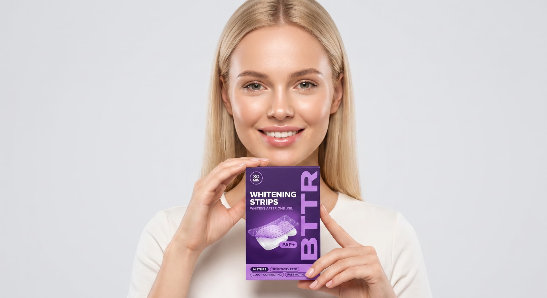 Person holding a BTTR Smile whitening strips box